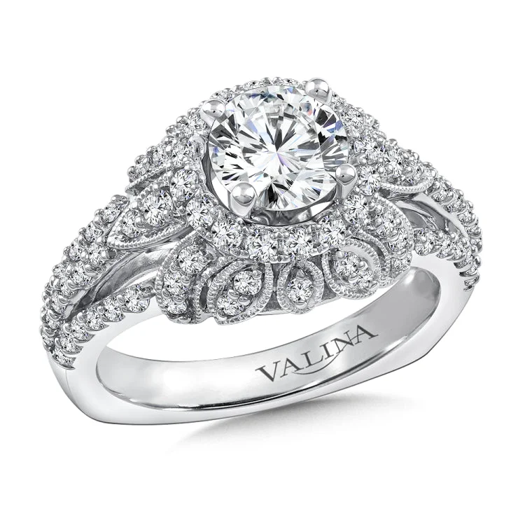 Diamond halo engagement ring mounting with a milgrain decorative skirt and side stones set in 14k white gold.