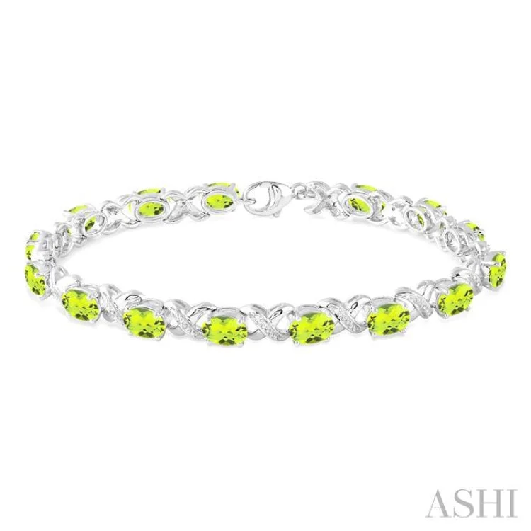 7x5 mm Oval Cut Peridot and 1/20 Ctw Round Cut Diamond Fashion Bracelet in Sterling Silver